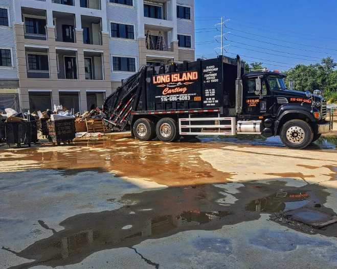black dumpster outside a building
