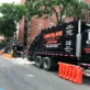 black dumpster with a long island carting logo